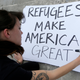 Photo of protester preparing a sign for a rally against President Donald Trump’s executive order on Muslim immigration in Miami via AP.
